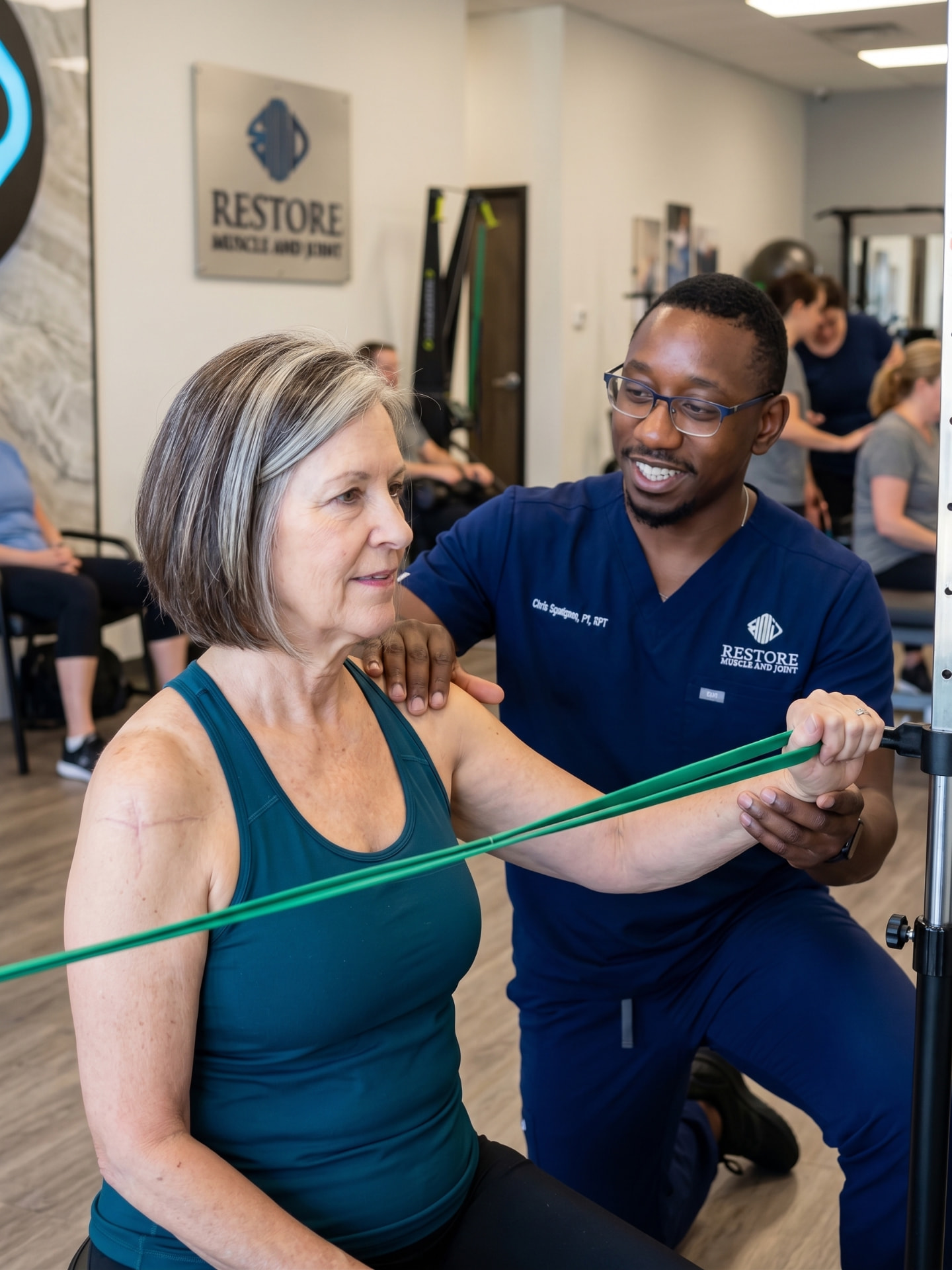 Physical therapist using resistance band therapy for shoulder rehabilitation in Kansas City
